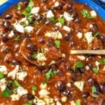 Birria-inspired black bean stew with rice, feta, cilantro, and lime.