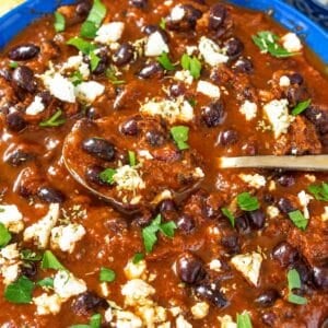 Birria-inspired black bean stew with rice, feta, cilantro, and lime.