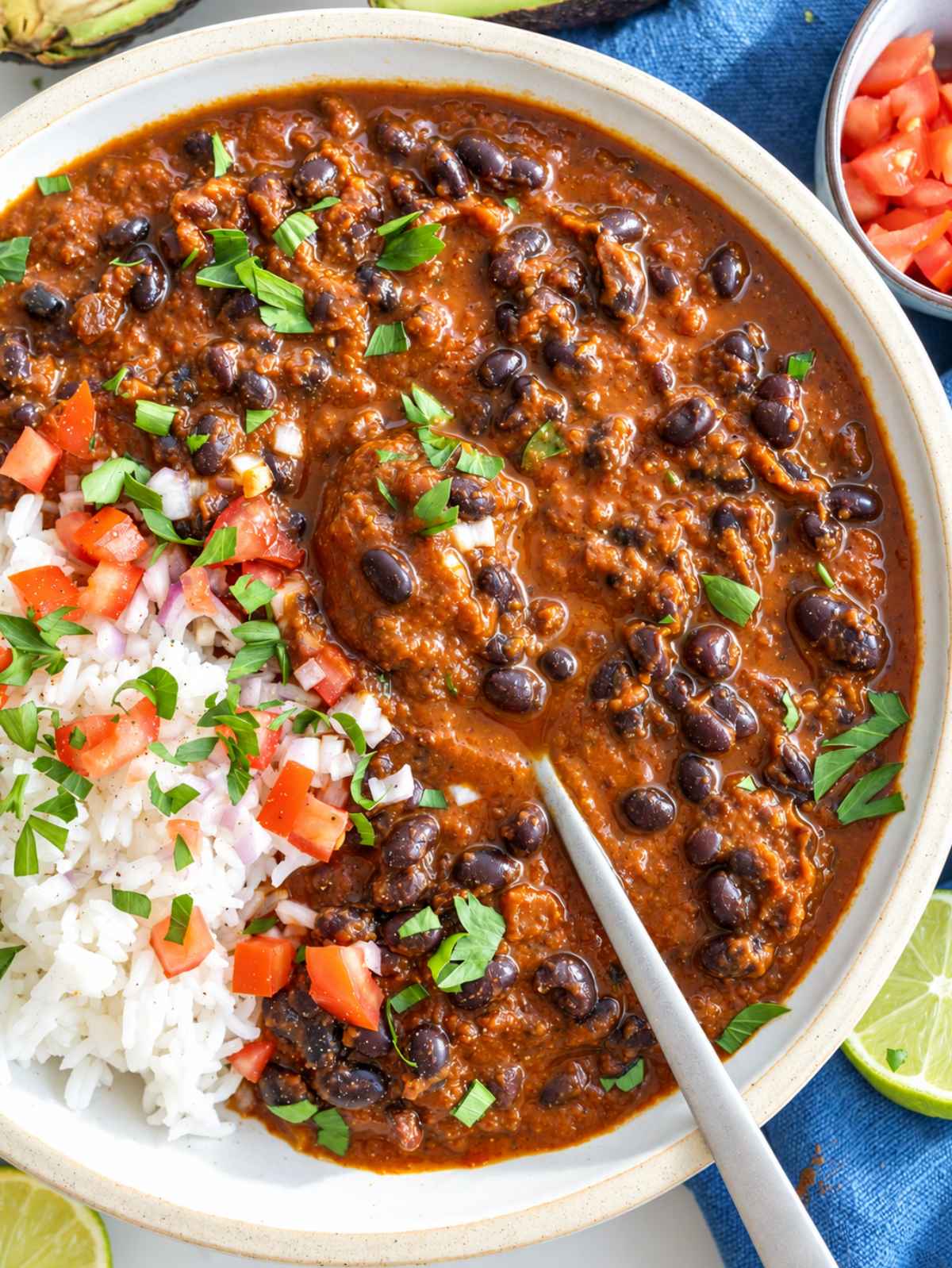 Black bean stew over rice with feta, red onion, cilantro, and lime.