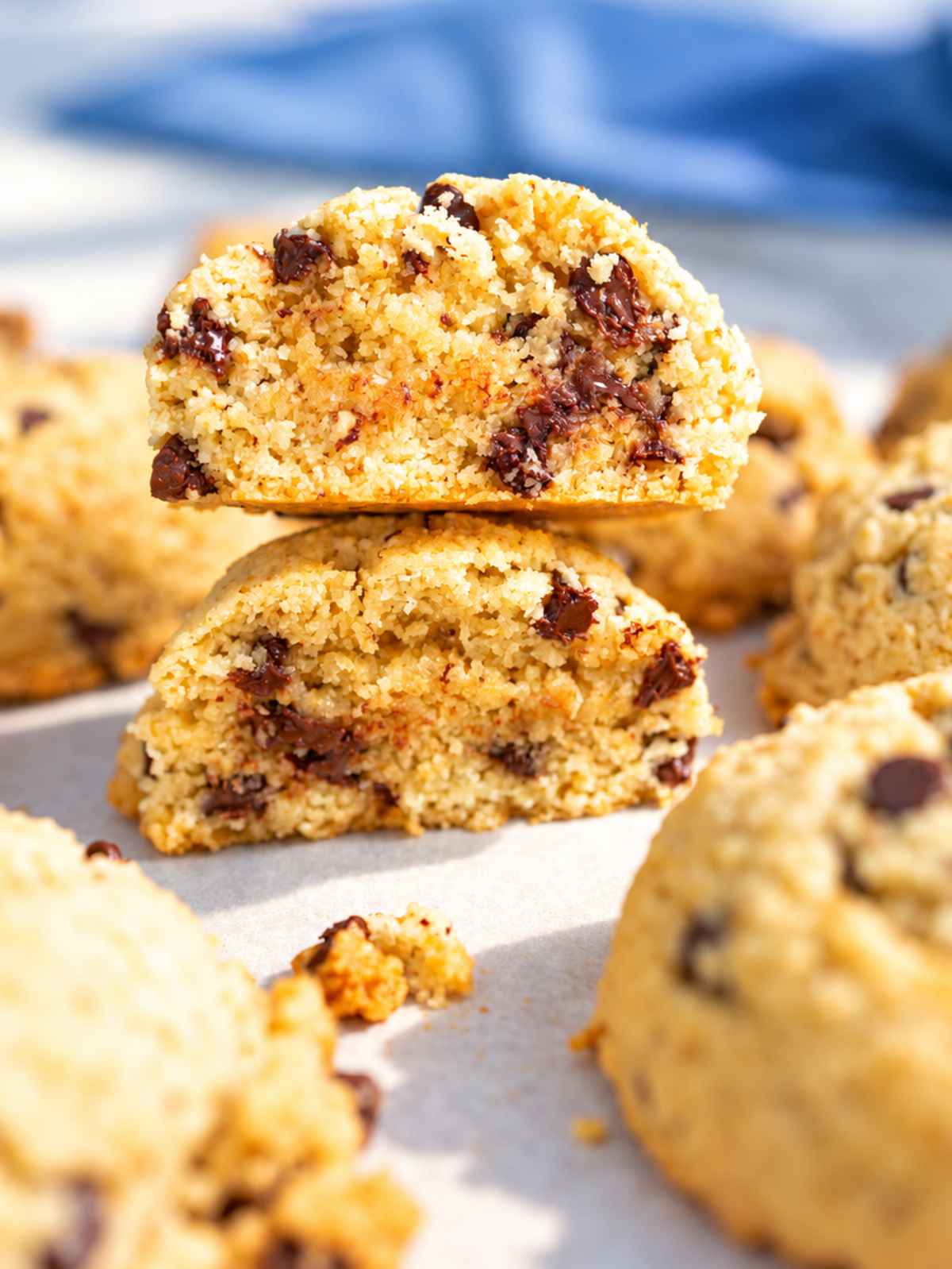 Close-up of a broken chocolate chip cookie showing its thick, moist center and rustic texture.