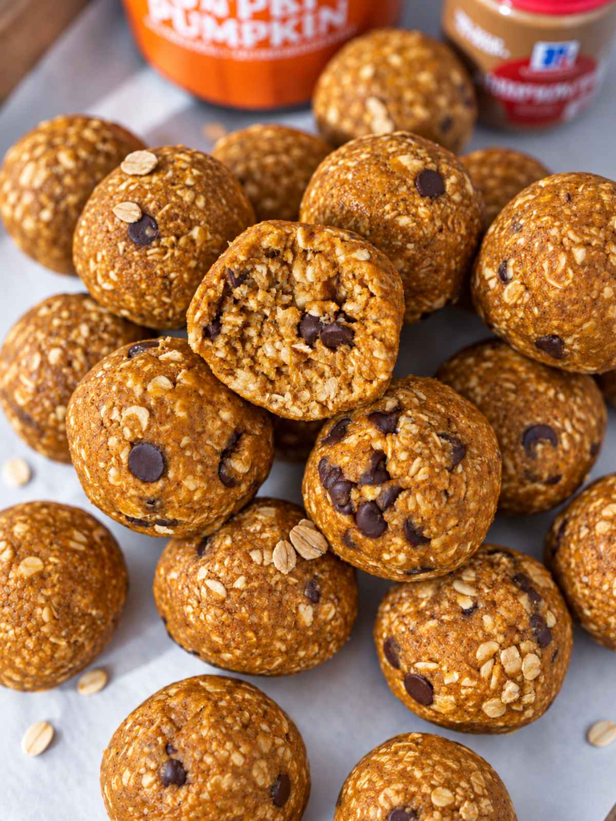 Close-up of soft, chewy pumpkin energy balls with dark chocolate chips.