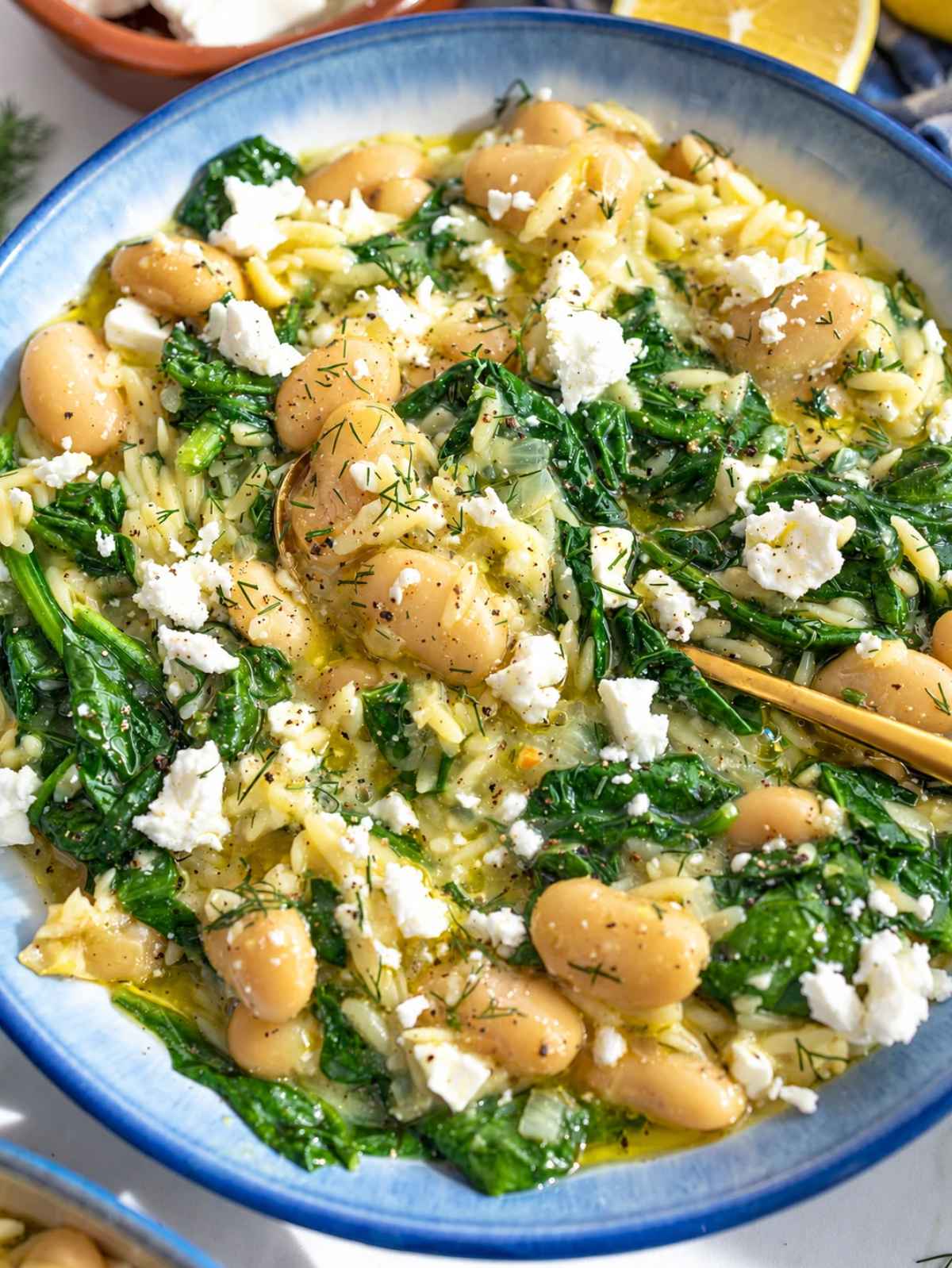 Close-up of tender orzo, creamy butter beans, spinach, and crumbled feta.