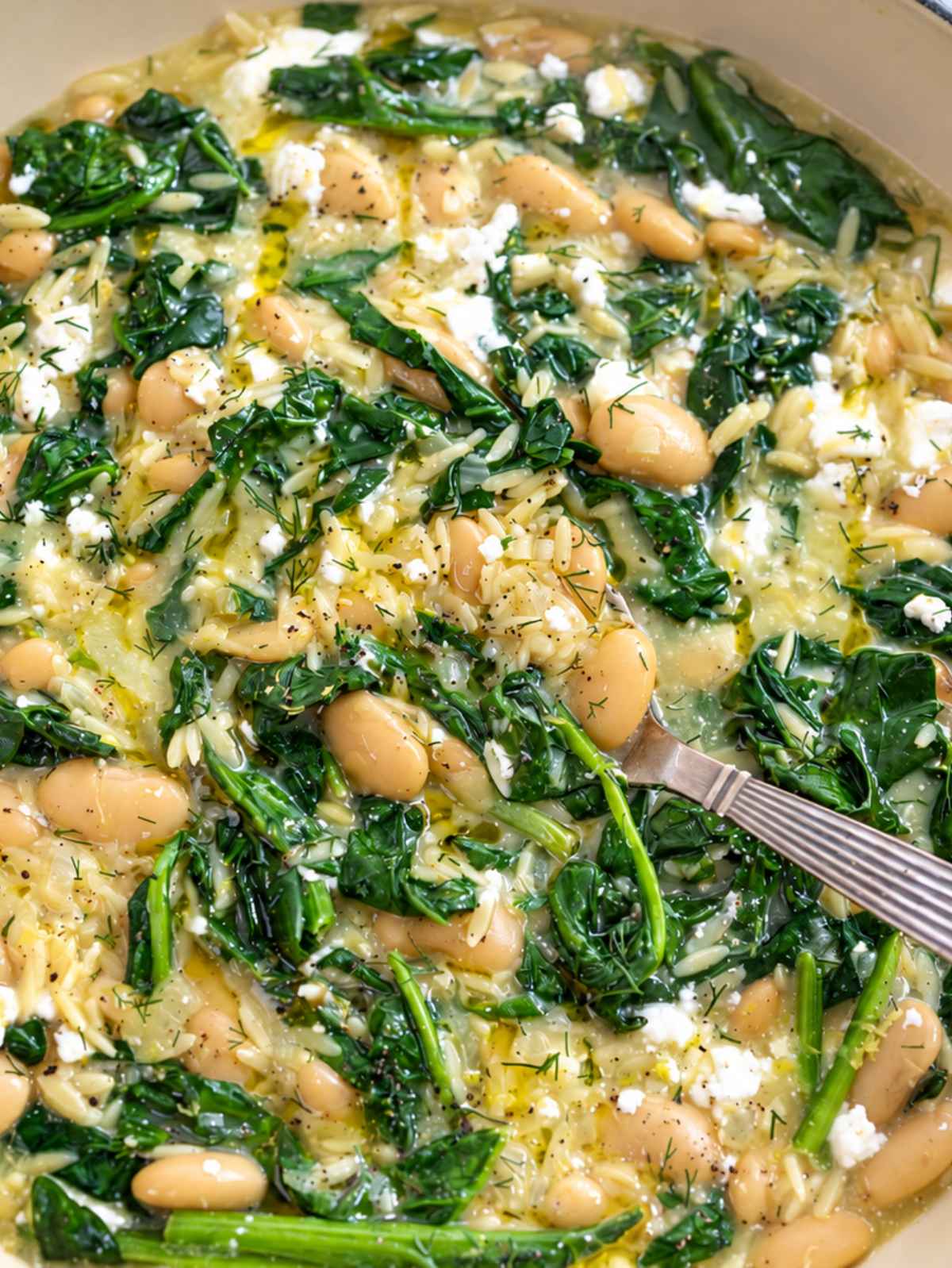 Creamy Greek butter beans orzo with spinach, crumbled feta, and dill.
