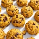 Golden pumpkin cookies with chocolate chips dotting their gently rounded tops.