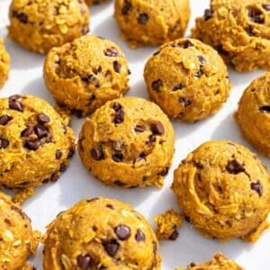 Golden pumpkin cookies with chocolate chips dotting their gently rounded tops.