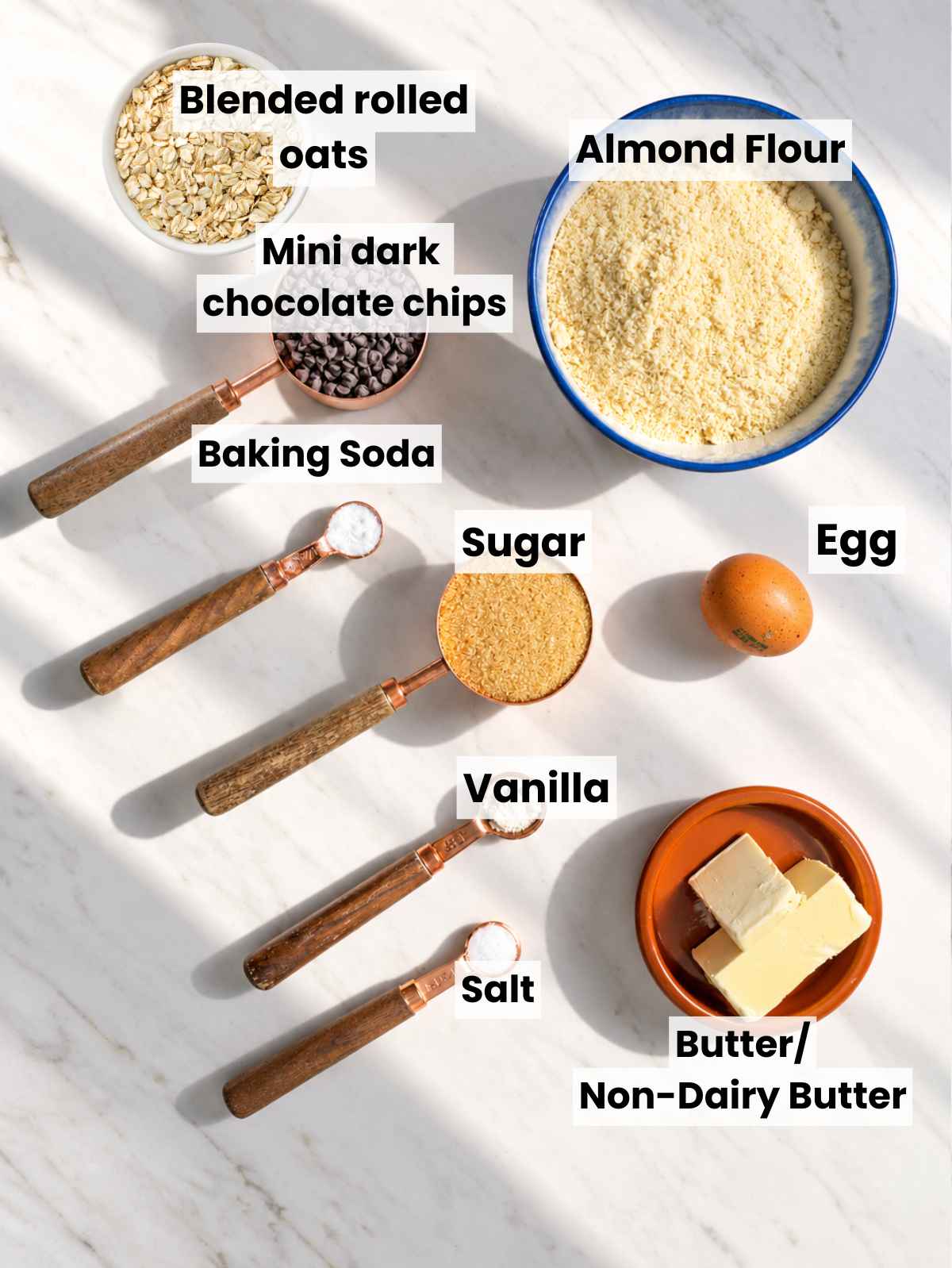 Ingredients for chocolate chip almond flour cookies on kitchen marble.