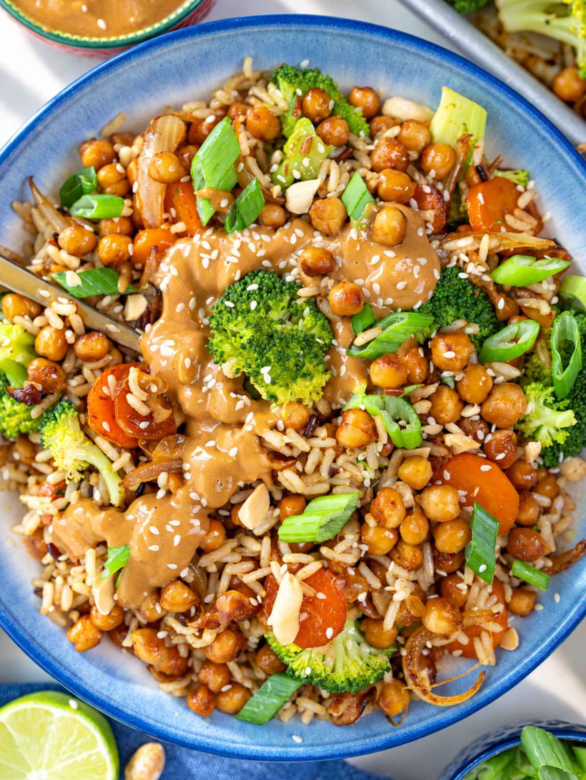 Overhead view of chickpea rice bowl with broccoli, carrots, and peanut sauce.