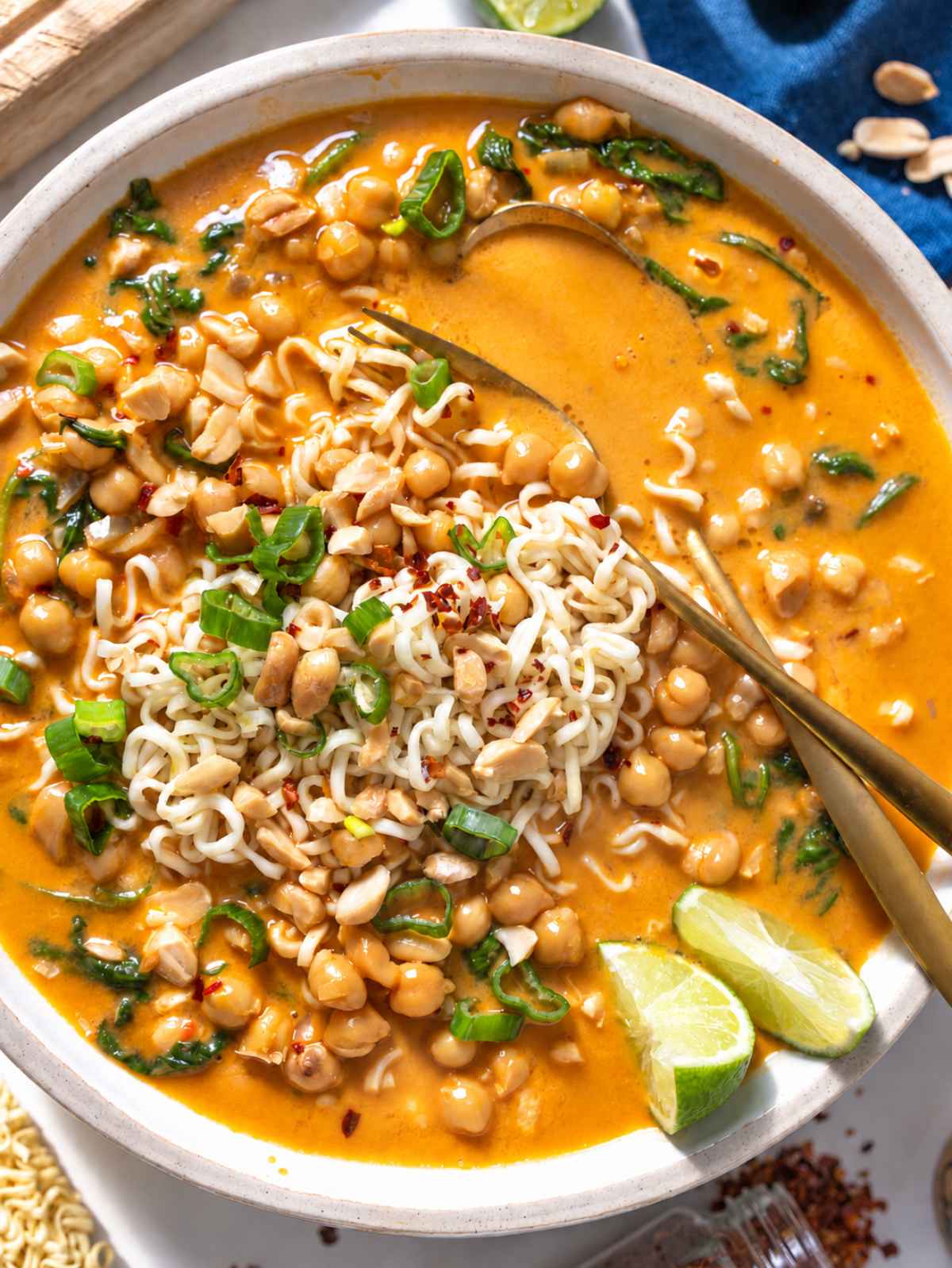 Peanut butter noodle soup with chickpeas, spinach, peanuts, and fresh cilantro.