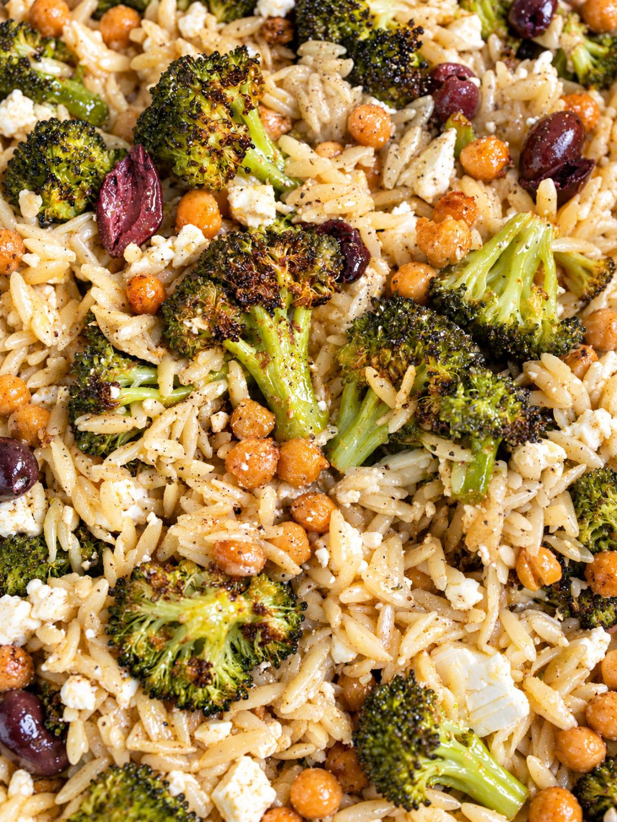 Roasted broccoli orzo with golden chickpeas, olives, and crumbled feta.