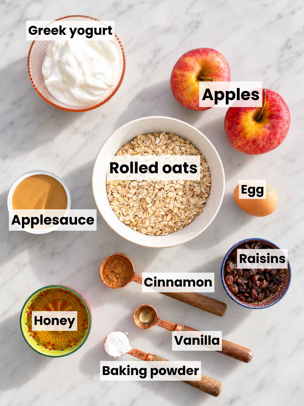 Rolled oats, apples, Greek yogurt, applesauce, honey, egg, cinnamon, and raisins.