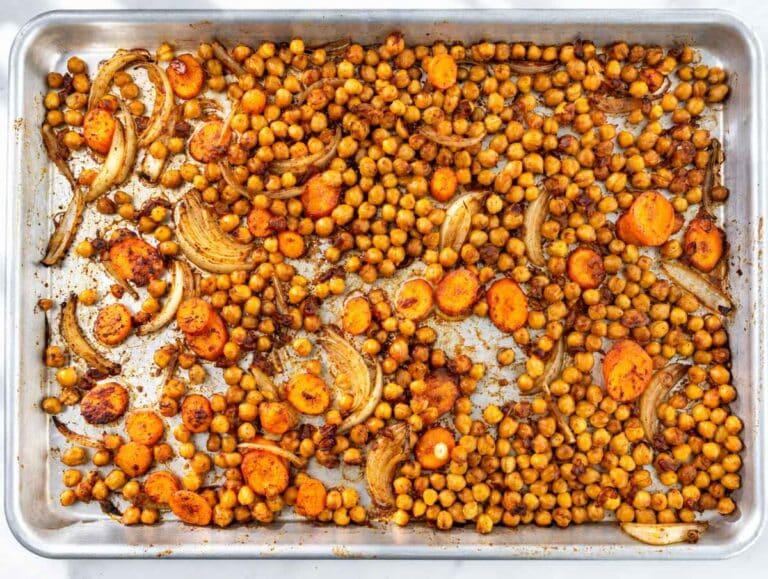 Step 1 Chickpeas, sliced carrots, and onions tossed with seasonings on a baking sheet.