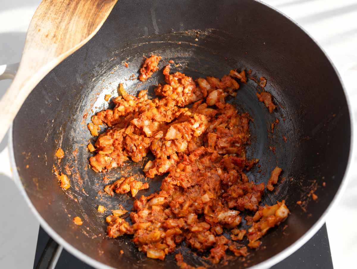 Step 1 Chopped onion, garlic, tomato paste, and spices sauteฬing in olive oil.