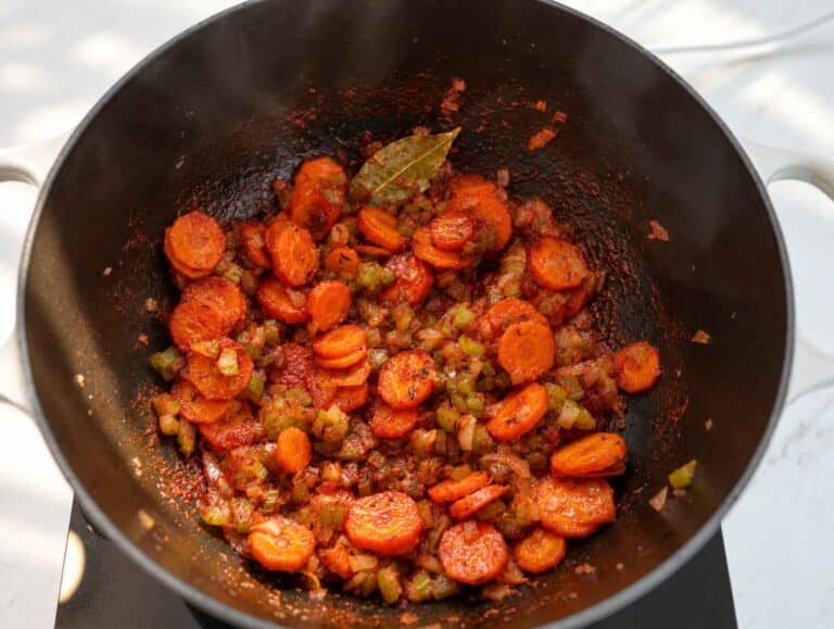 Step 1 Onion, carrots, celery, and tomato paste cooking in a large pot.