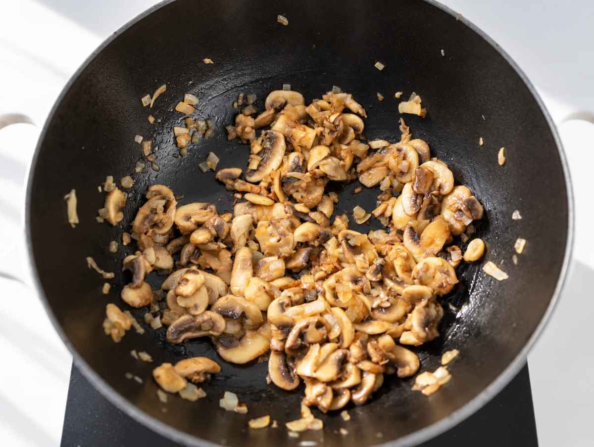 Step 1 Sliced mushrooms and chopped onions sauteฬing in a large pot.