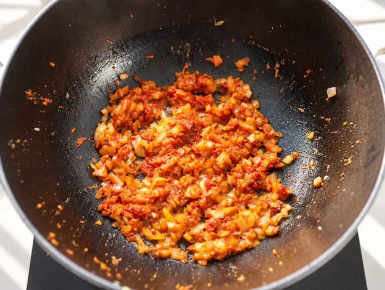 Step 1 Softened onion cooking with garlic, ginger, spices, and tomato paste.