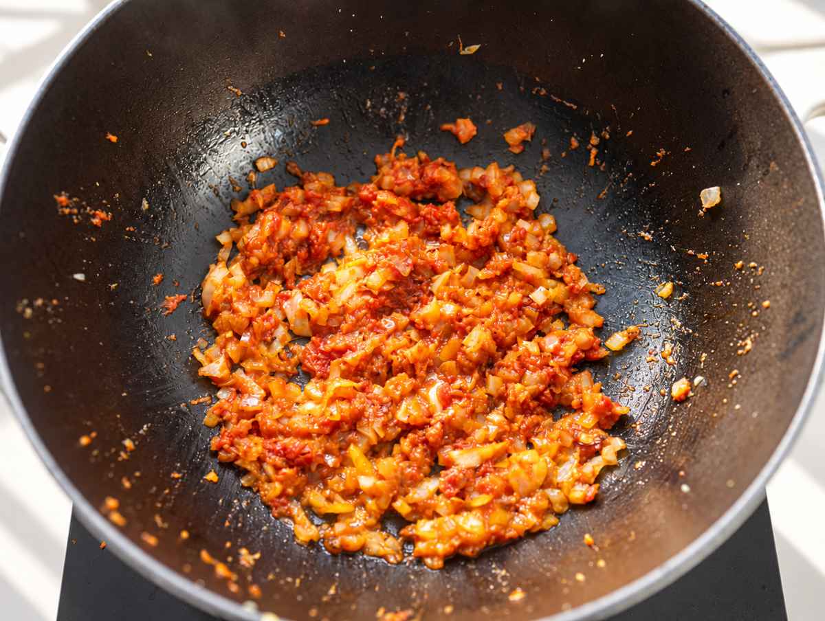 Step 1 Softened onion cooking with garlic, ginger, spices, and tomato paste.