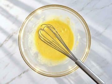Step 1 – Butter, sugar, egg, and vanilla mixed into a creamy mixture in a bowl.