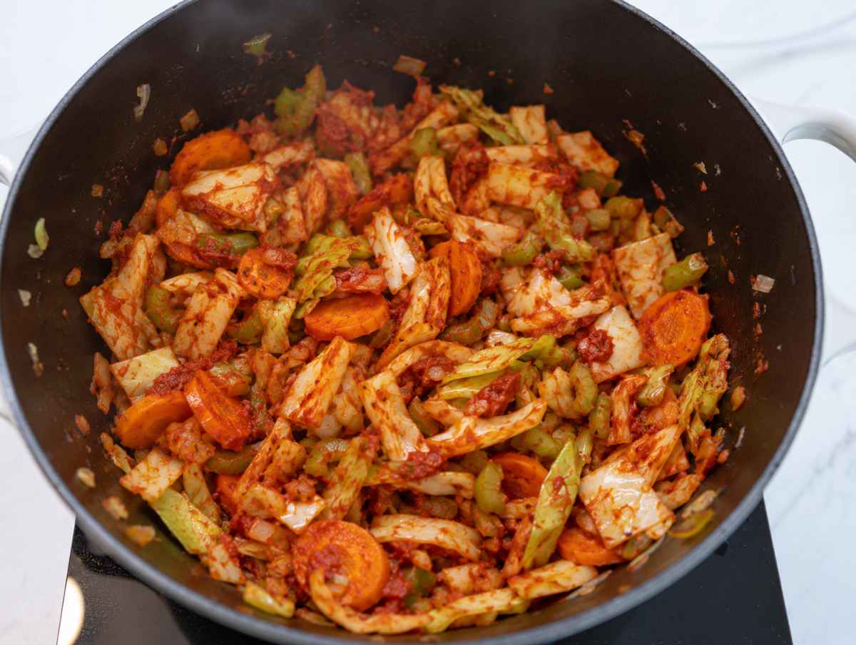 Step 2 Chopped green cabbage softening with sautéed vegetables and tomato paste