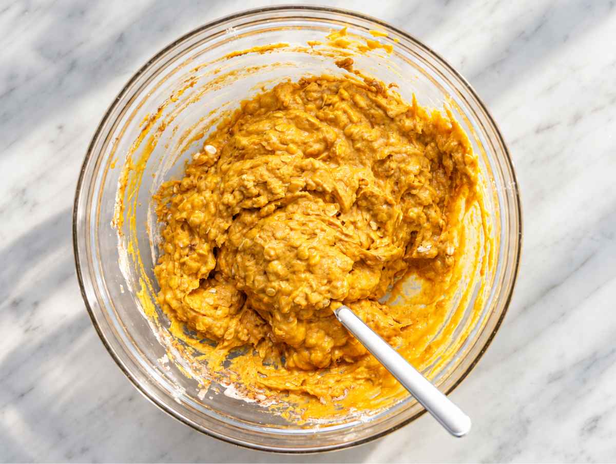 Step 2 Rolled oats, flour, and spices stirred into thick pumpkin muffin batter.