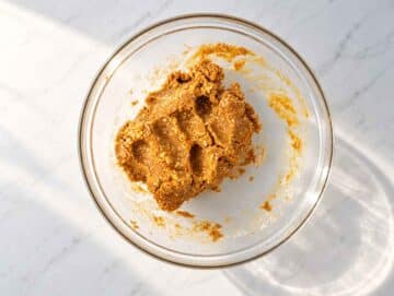 Step 2 Thick peanut butter cookie dough coming together in a mixing bowl.
