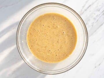 Step 2 – Mashed bananas, eggs, yogurt, sugar, and oil mixed in a bowl.