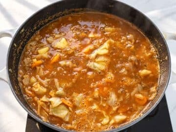 Step 3 Lentils, potatoes, and cabbage simmering together in a tomato broth.