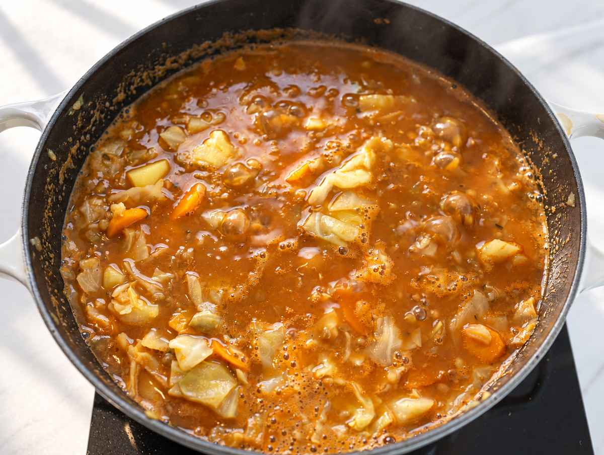 Step 3 Lentils, potatoes, and cabbage simmering together in a tomato broth.