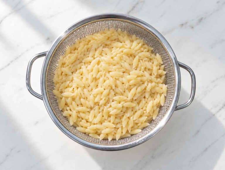 Step 3 Tender cooked orzo draining in a colander.