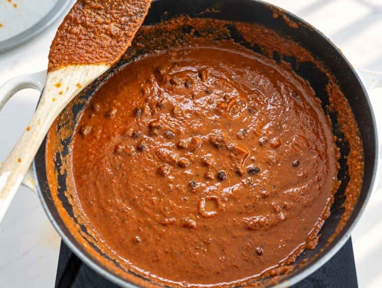 Step 3 Whole black beans simmering in thick, glossy, reddish-brown sauce.