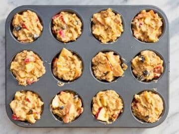 Step 3 apple oatmeal cups in baking pan before baking in the oven.
