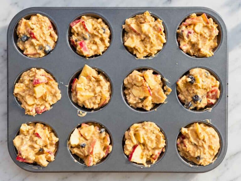 Step 3 apple oatmeal cups in baking pan before baking in the oven.