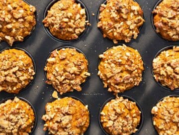 Step 4 Baked muffins with golden walnut tops cooling in a muffin pan.