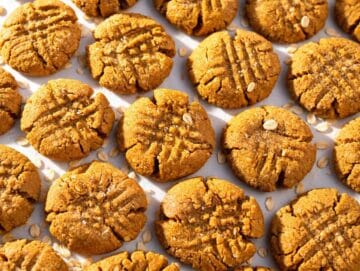 Step 4 Freshly baked peanut butter cookies cooling on a parchment-lined baking sheet.
