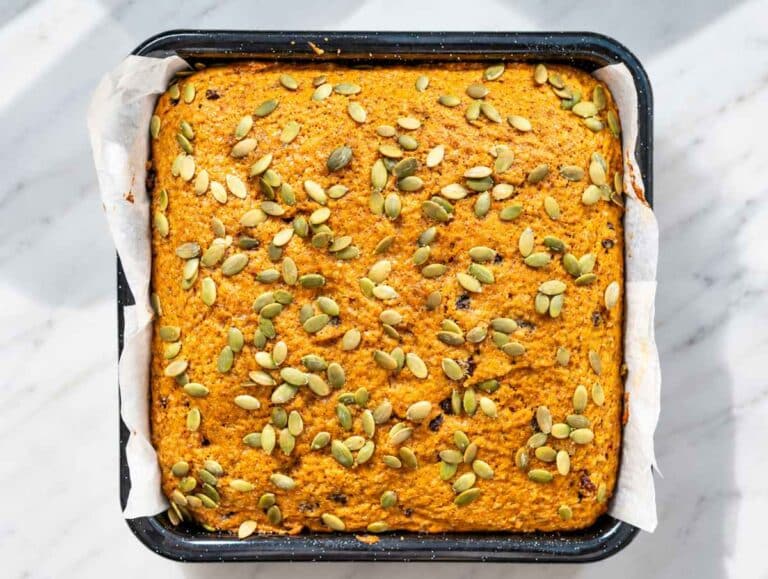 Step 4 Freshly baked pumpkin cake cooling with a golden pumpkin seed topping.