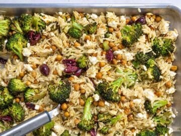 Step 4 Orzo, roasted broccoli, chickpeas, olives, feta, and dressing tossed on the pan.