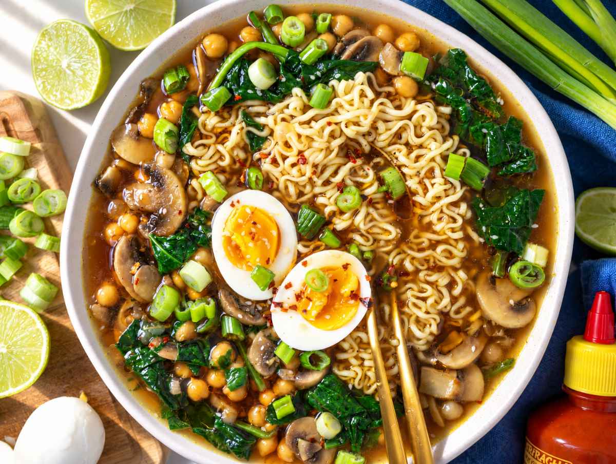 Step 5 chickpea noodle soup serve in a bowl with eggs, green onions and sesame seeds.