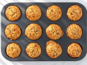 Step 5 – Freshly baked golden muffins cooling in a nonstick muffin pan.