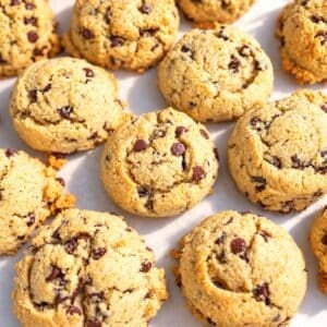 Thick, bakery-style almond flour cookies on parchment paper.