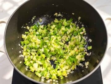 step 1 Chopped onion, celery, and green bell pepper softening in a pot.